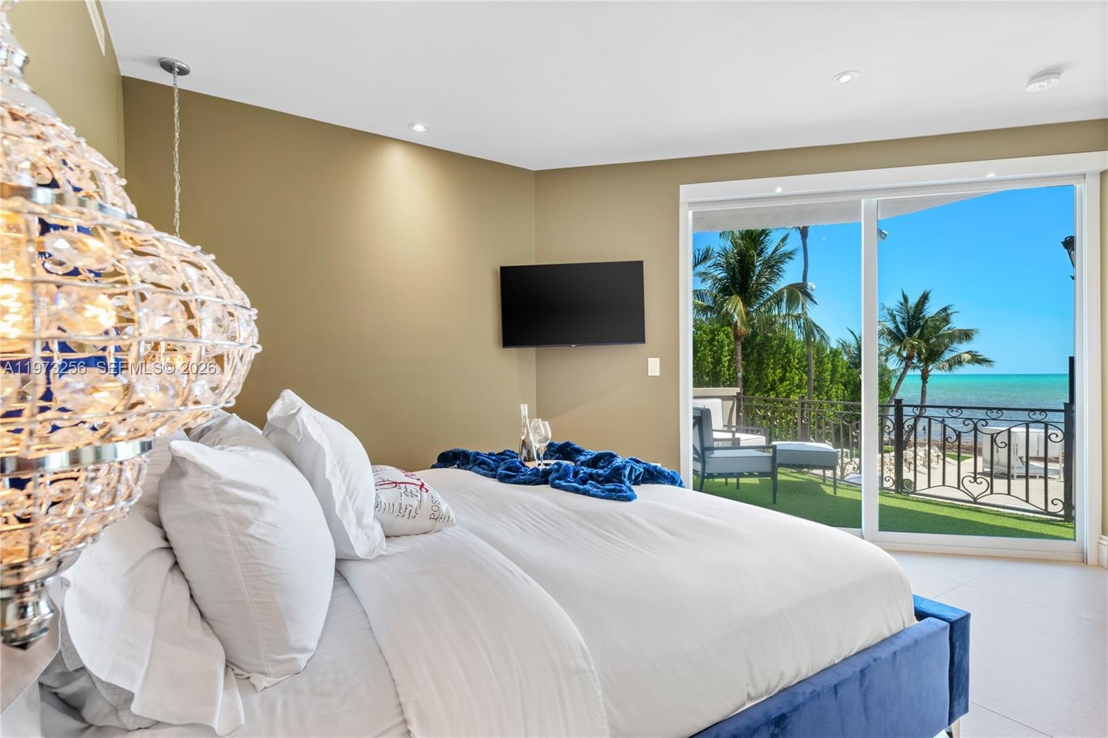 Ocean-view bedroom with pristine white linens