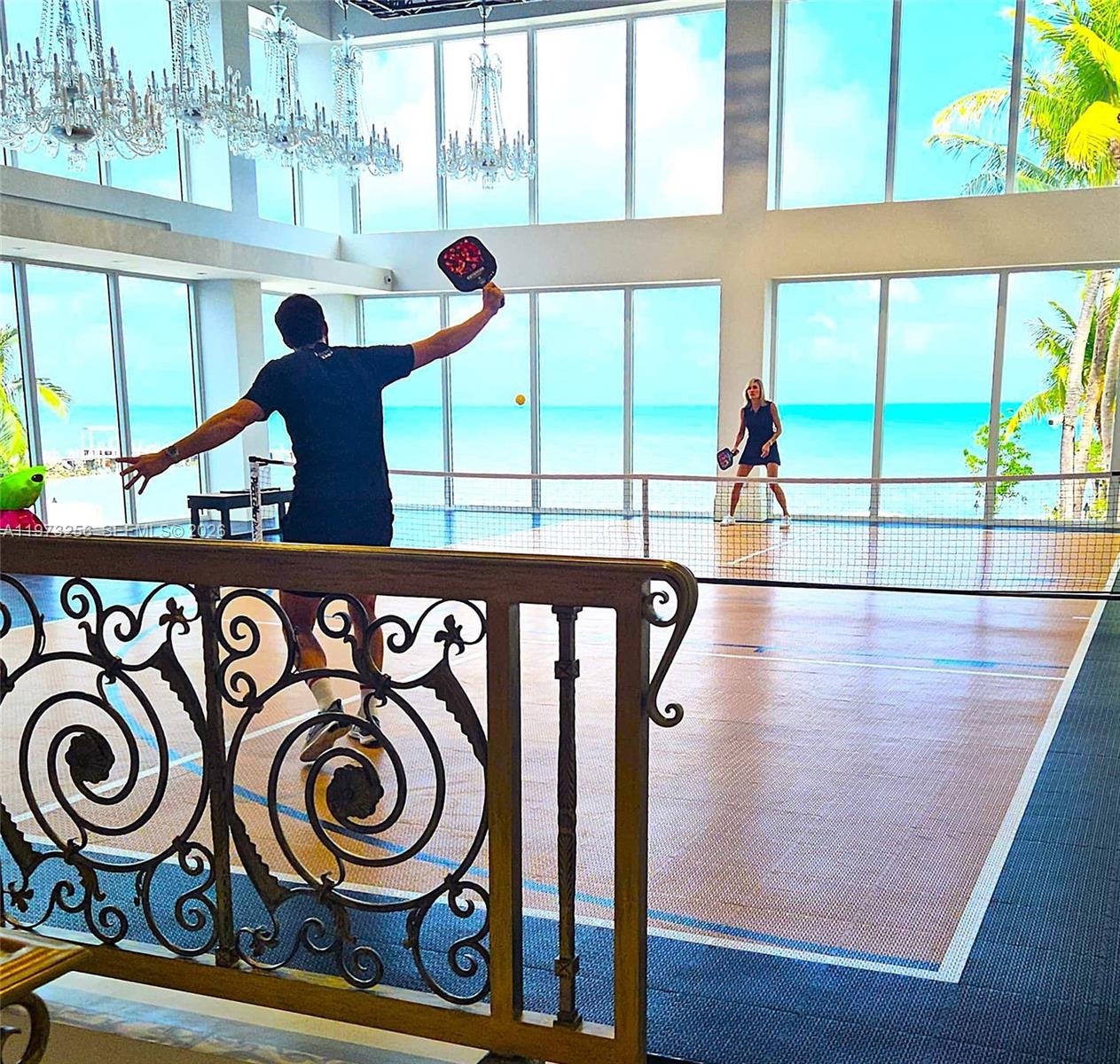 Wrought-iron balcony detail with ocean backdrop